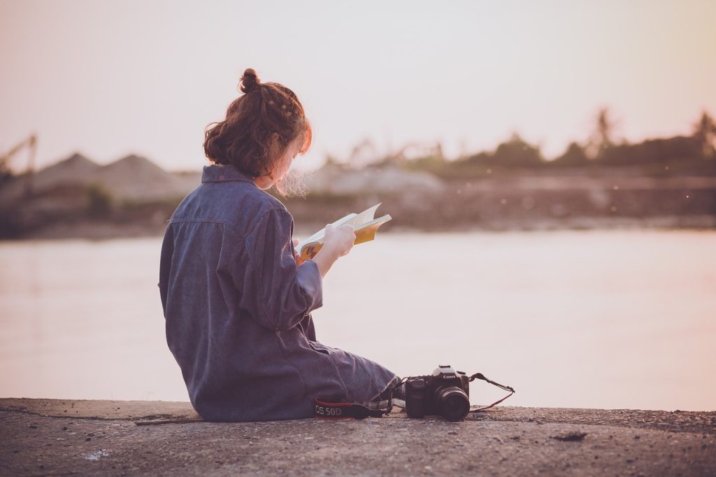 Woman reading a physical book